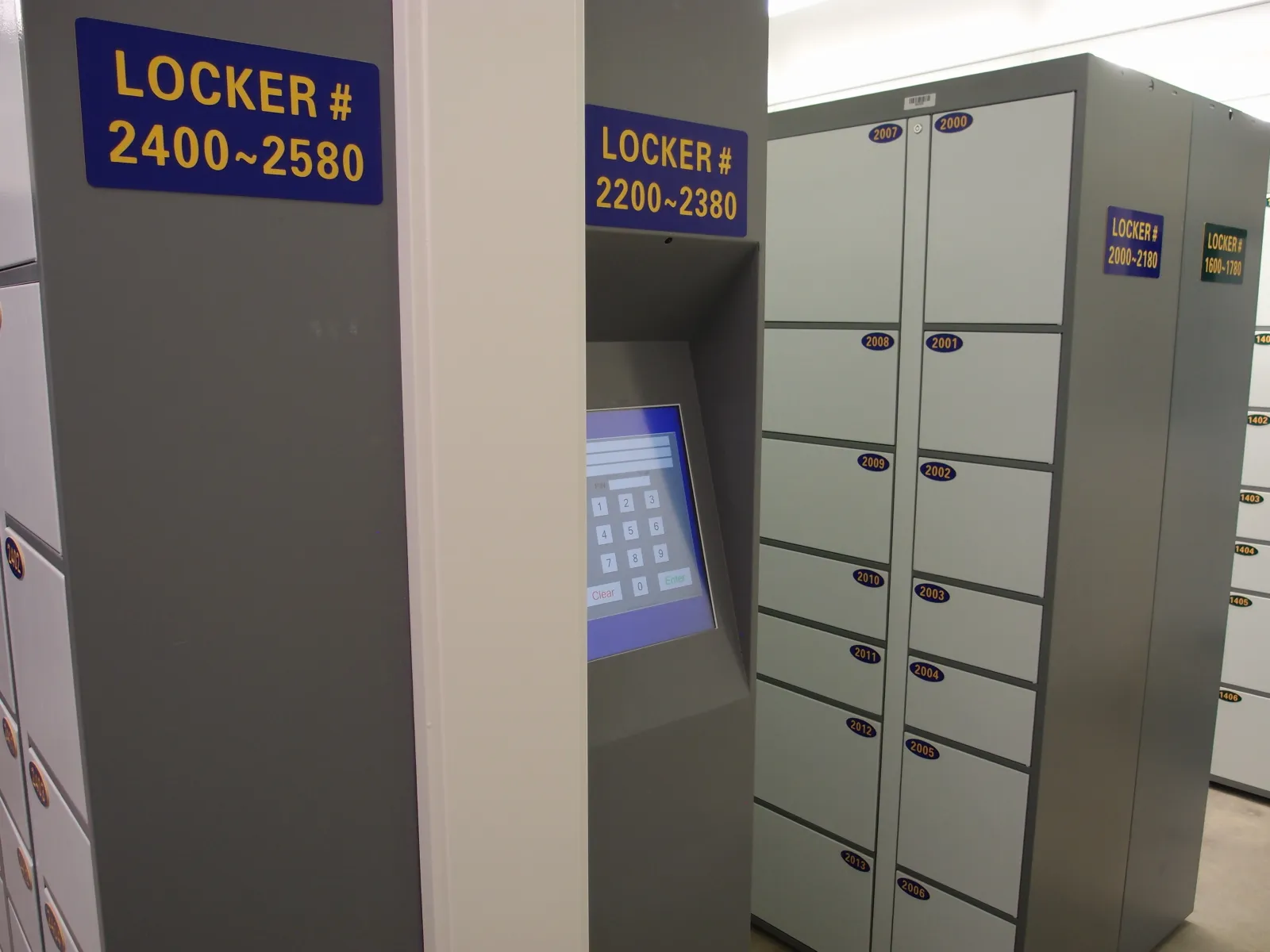 Self-serve package-pickup terminal with a 6-digit PIN keypad at In Out Parcel